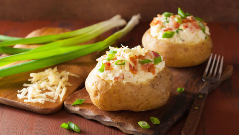 Stuffed baked potatoes with cheese, bacon and spring onion